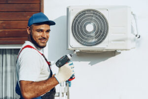 A man installing a Heat Pump